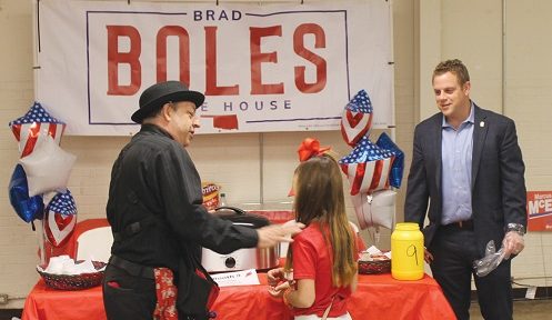Photo by Wayne Watts, CTCN Publisher A magician from a prior Chili Cookoff shows sleight-of hand tricks to a youngster while Oklahoma House District 51 Rep. Brad Boles watches.