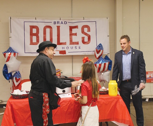 Photo by Wayne Watts, CTCN Publisher A magician from a prior Chili Cookoff shows sleight-of hand tricks to a youngster while Oklahoma House District 51 Rep. Brad Boles watches.